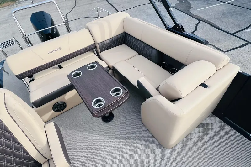 Slide: The Image of Luxurious seating area on 2024 Harris Sunliner 250 pontoon boat with cupholders and elegant design. - 10