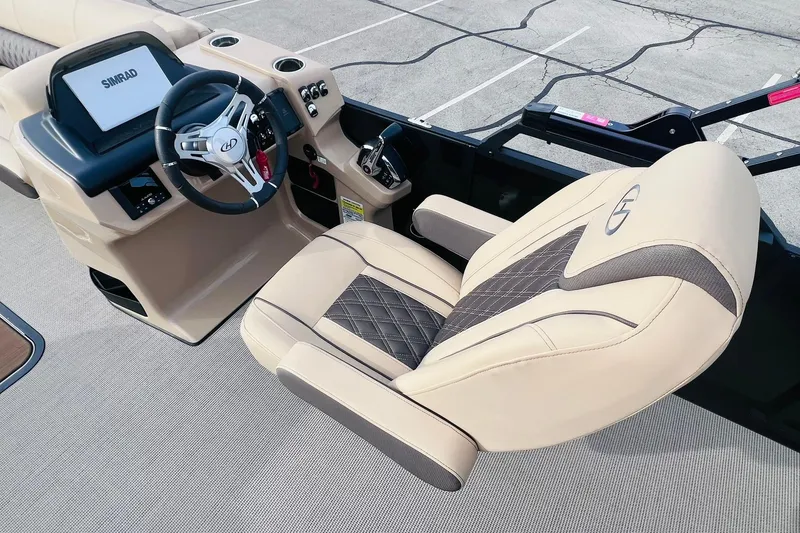 Slide: The Image of 2024 Harris Sunliner 250 boat interior with beige captain's chair and steering console. - 13