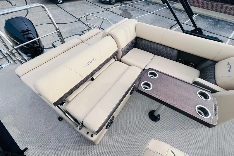 Slide: The Image of Luxurious seating on 2024 Harris Sunliner 250 boat with elegant table and cup holders. - 14