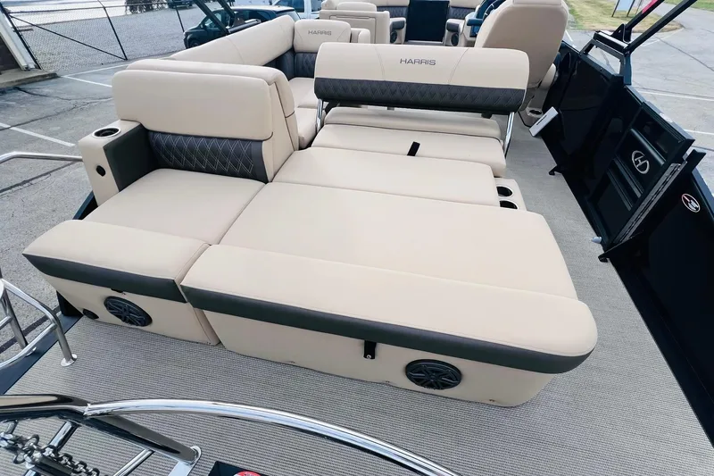 Slide: The Image of 2024 Harris Sunliner 250 boat interior with luxurious beige seating and integrated speakers. - 17
