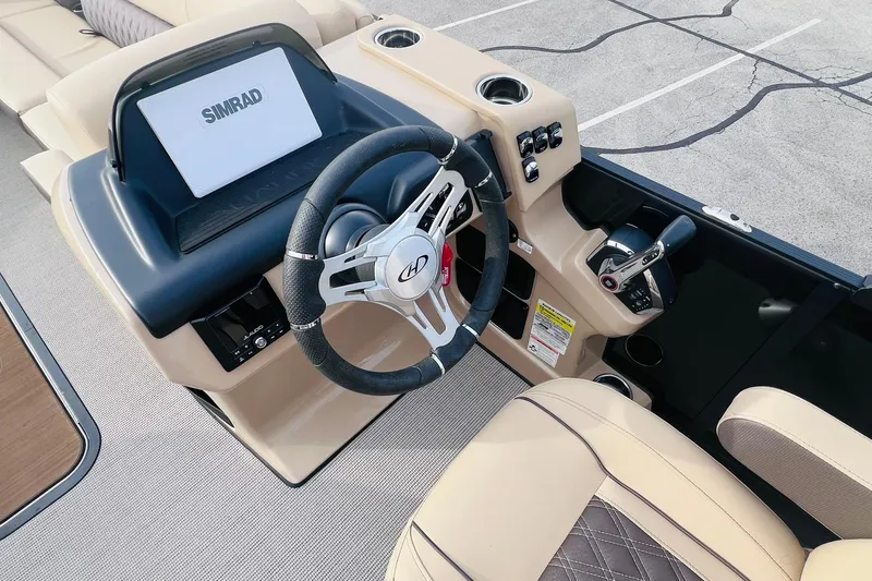 Slide: The Image of 2024 Harris Sunliner 250 boat dashboard with steering wheel and Simrad display. - 19