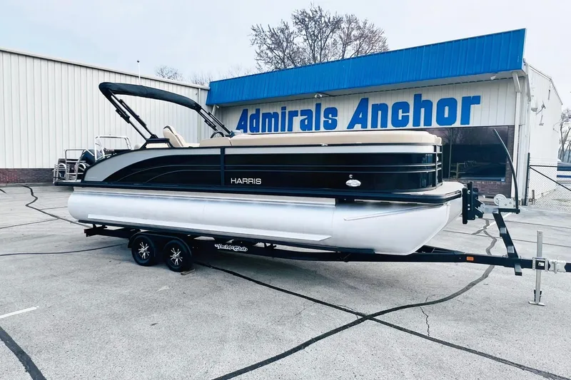 Slide: The Image of 2024 Harris Sunliner 250 pontoon boat on trailer at Admirals Anchor dealership. - 2