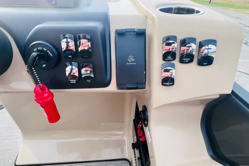 Slide: The Image of Control panel of 2024 Harris Sunliner 250 boat with switches and ignition key. - 23