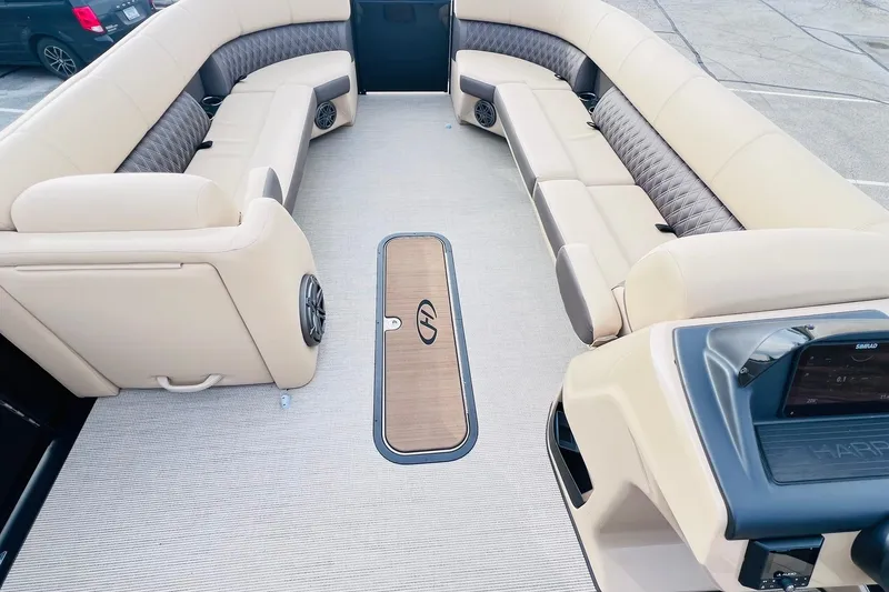 Slide: The Image of 2024 Harris Sunliner 250 interior with beige seating and modern dashboard. - 30
