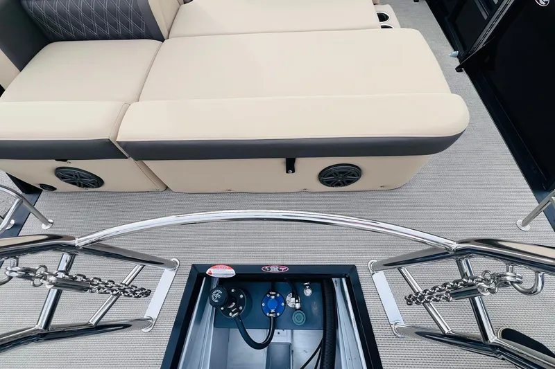 Slide: The Image of 2024 Harris Sunliner 250 boat interior with beige seating and stainless steel railings. - 31