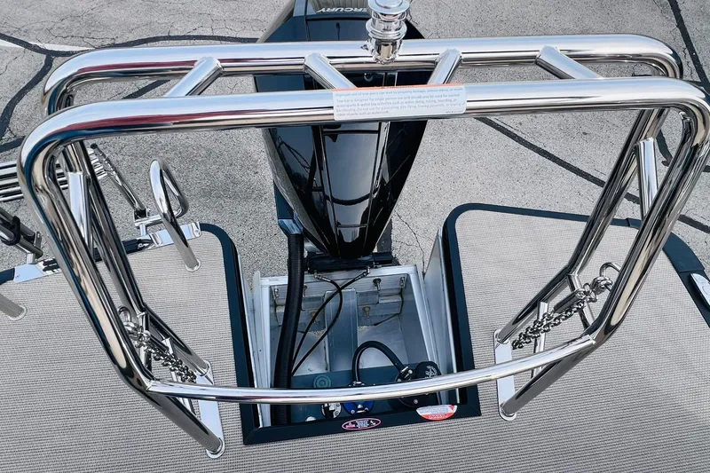 Slide: The Image of 2024 Harris Sunliner 250 boat with stainless steel railing and engine compartment. - 38