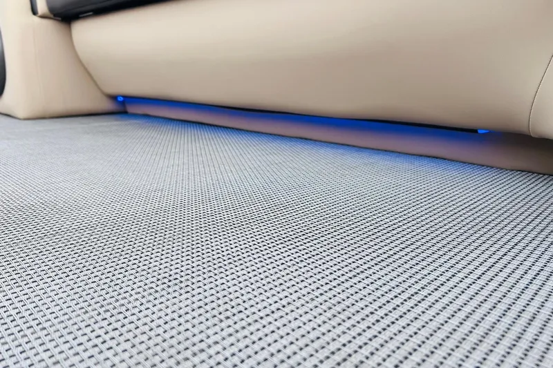 Slide: The Image of 2024 Harris Sunliner 250 interior with textured flooring and ambient blue lighting. - 39