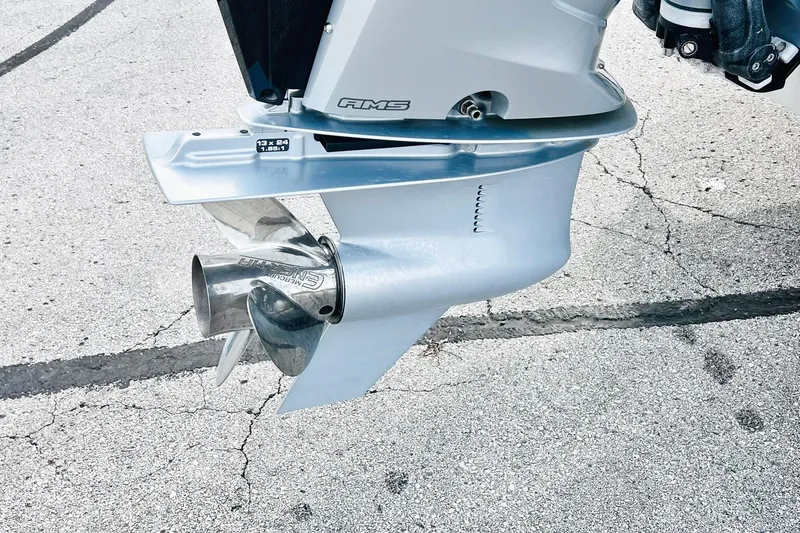 Slide: The Image of 2024 Harris Sunliner 250 outboard motor close-up on pavement background. - 43