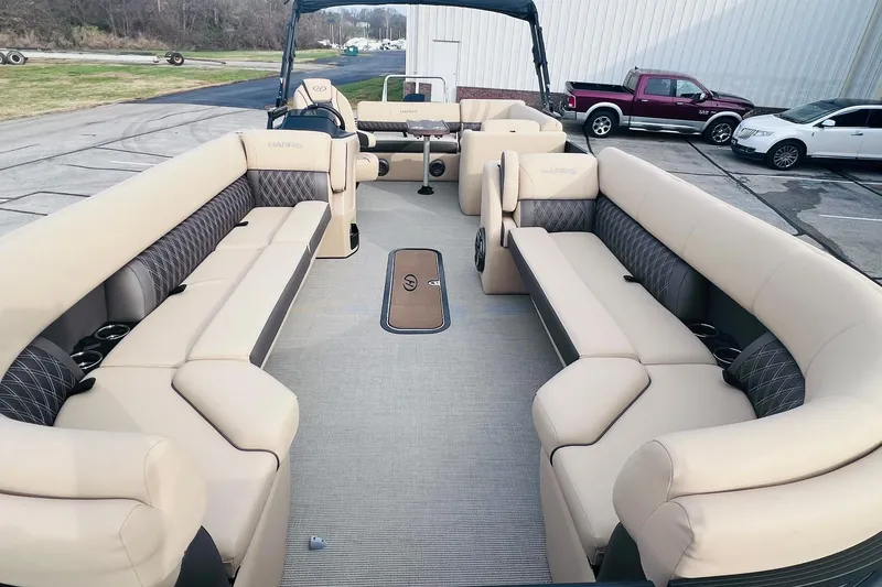 Slide: The Image of 2024 Harris Sunliner 250 pontoon boat with spacious seating and modern design. - 8