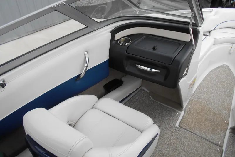 Slide: The Image of Interior of 2012 Crownline 205 SS boat with white seating and blue accents. - 10