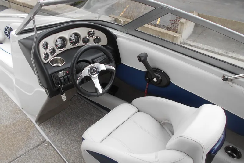 Slide: The Image of Interior of 2012 Crownline 205 SS boat with steering wheel and dashboard controls. - 11