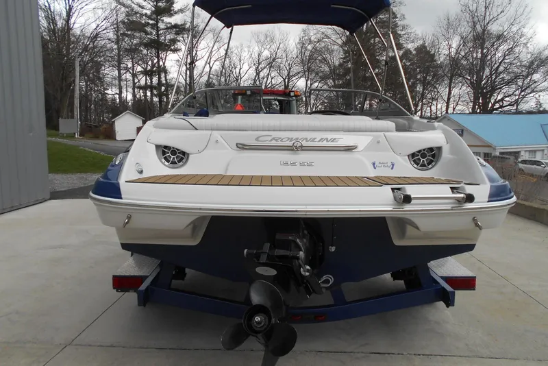 Slide: The Image of 2012 Crownline 205 SS boat on trailer, rear view, parked outdoors. - 14