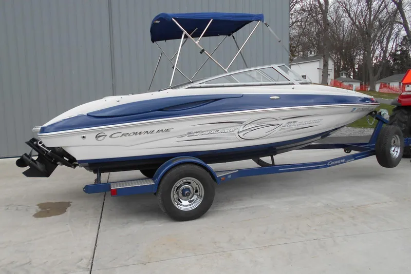 Slide: The Image of 2012 Crownline 205 SS boat on trailer with blue and white design. - 2