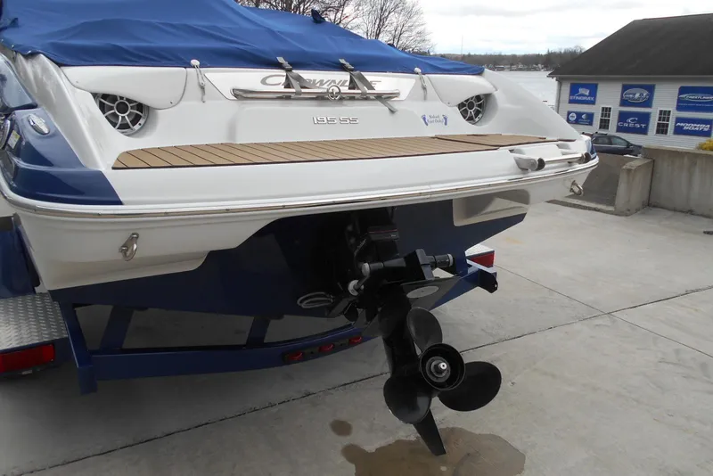 Slide: The Image of 2012 Crownline 205 SS boat with blue cover and visible propeller on trailer. - 6