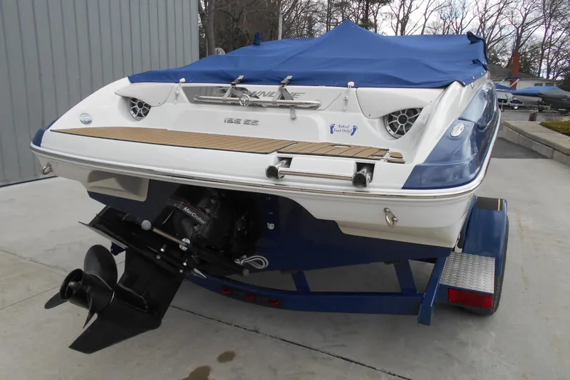 Slide: The Image of 2012 Crownline 205 SS boat with blue cover on trailer, rear view. - 7