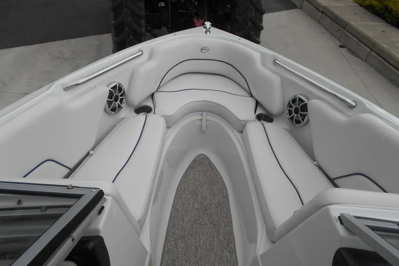 Slide: The Image of 2012 Crownline 205 SS boat interior with white seating and speakers. - 9