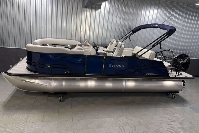 The Image of 2026 Sylvan Mirage X3 CLZ DH pontoon boat in showroom, featuring sleek design and modern amenities. - 0