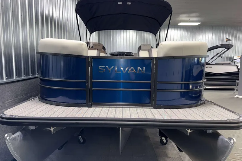 Slide: The Image of 2026 Sylvan Mirage X3 CLZ DH pontoon boat in showroom, blue exterior, modern design. - 19