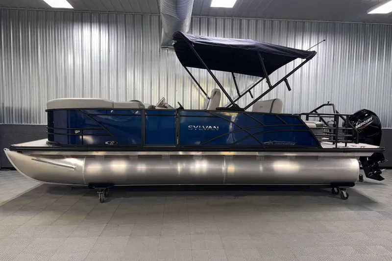 Slide: The Image of 2026 Sylvan Mirage X3 CLZ DH pontoon boat in a showroom setting. - 22