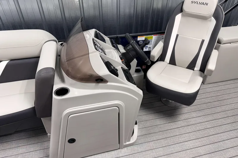 Slide: The Image of 2026 Sylvan Mirage X3 CLZ DH boat interior with steering console and captain's chair. - 7
