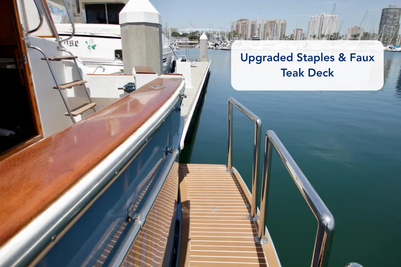 Slide: The Image of Upgraded Symbol 51 yacht with faux teak deck, docked in marina, 1984 model. - 14