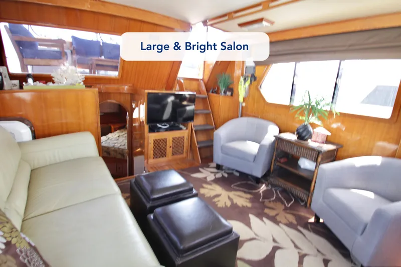 Slide: The Image of Large, bright salon in 1984 Symbol 51 yacht with cozy seating and decor. - 27