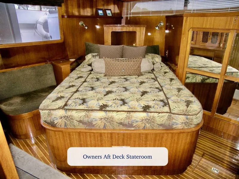Slide: The Image of Luxurious 1984 Symbol 51 yacht stateroom with wood paneling and patterned bedding. - 29