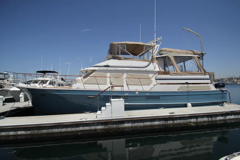 Slide: The Image of 1984 Symbol 51 yacht docked at marina under clear blue sky. - 3