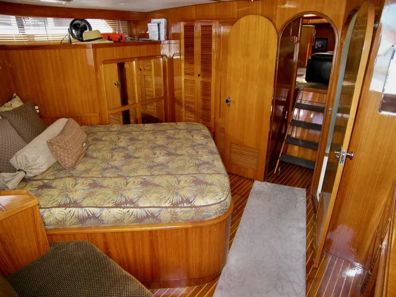 Slide: The Image of Luxurious 1984 Symbol 51 yacht interior with wood paneling and cozy bedding. - 32