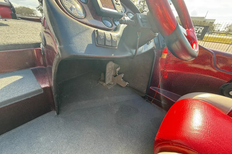 Slide: The Image of Interior of a 2000 Triton Tr-186 boat showing steering wheel and dashboard controls. - 16