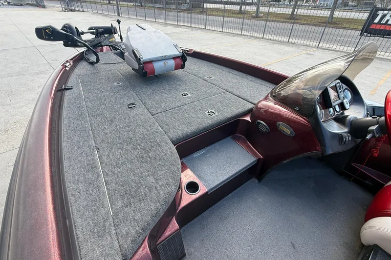 Slide: The Image of 2000 Triton Tr-186 boat interior with carpeted deck and steering console. - 9