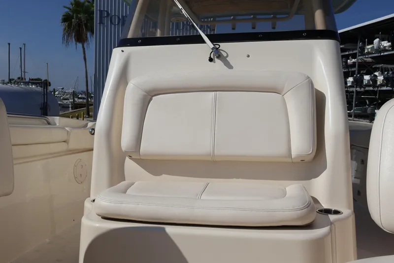 Slide: The Image of 2017 Grady-White Canyon 306 boat seat, beige upholstery, marina background. - 56