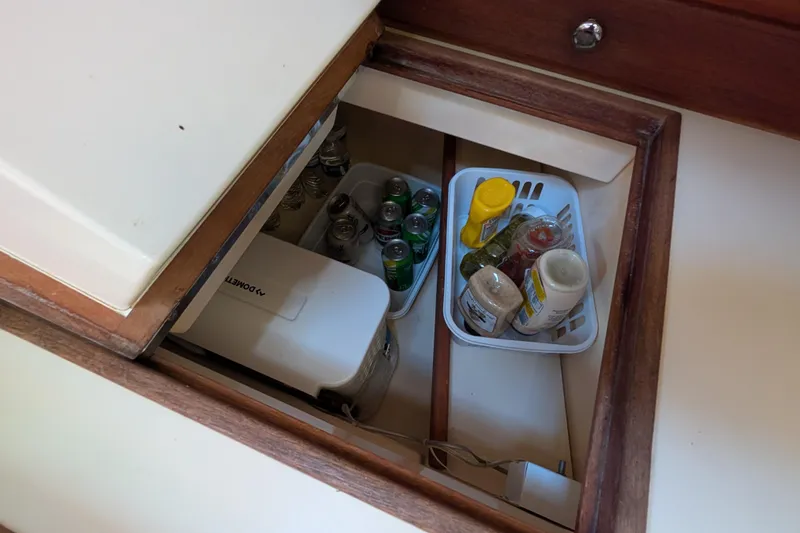 Slide: The Image of Storage compartment on 1999 Island Packet 320 yacht with beverages and condiments. - 13