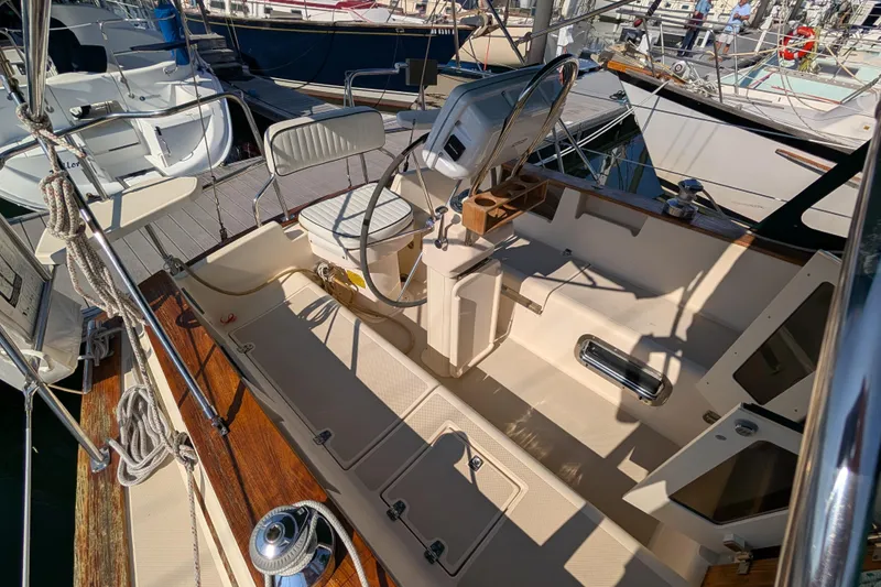 Slide: The Image of Cockpit of 1999 Island Packet 320 sailboat with steering wheel and seating. - 21