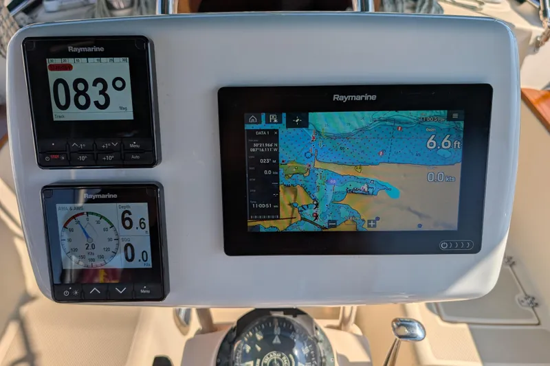 Slide: The Image of Navigation instruments on a 1999 Island Packet 320 sailboat, featuring Raymarine displays. - 24