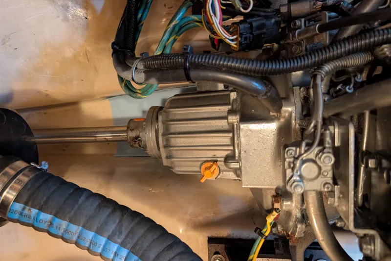 Slide: The Image of Engine compartment of a 1999 Island Packet 320 sailboat, showing mechanical components and wiring. - 45