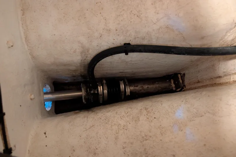 Slide: The Image of 1999 Island Packet 320 sailboat shaft and hose in engine compartment. - 46