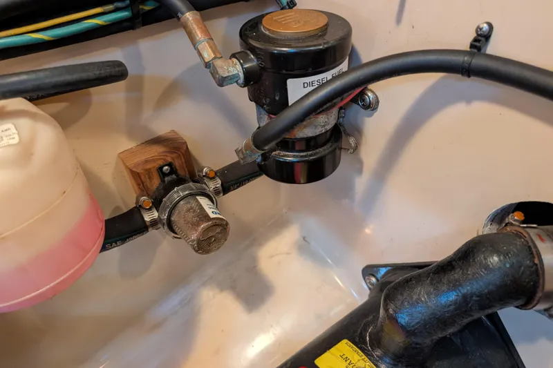 Slide: The Image of Diesel fuel system components in a 1999 Island Packet 320 sailboat engine compartment. - 48