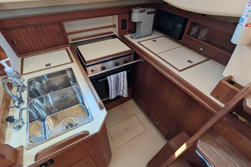 Slide: The Image of 1999 Island Packet 320 yacht kitchen with sink, stove, and appliances. - 5