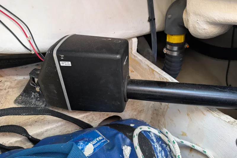 Slide: The Image of Autopilot mechanism inside a 1999 Island Packet 320 sailboat, featuring wiring and marine equipment. - 51