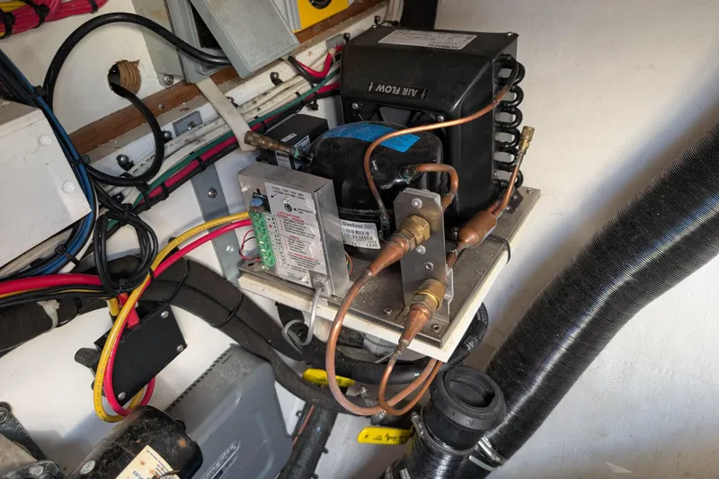 Slide: The Image of Electrical system inside a 1999 Island Packet 320 boat, featuring wiring and components. - 52