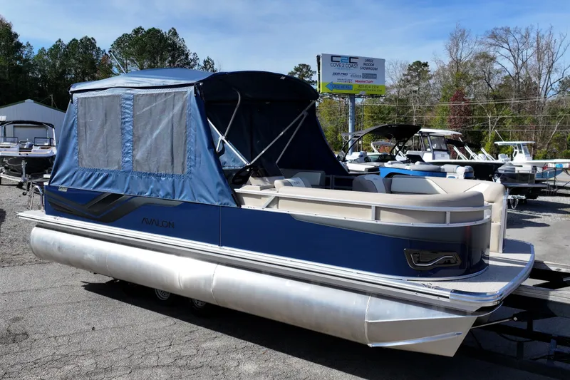 The Image of 2026 Avalon Venture 85 Rear Fish pontoon boat with blue canopy, parked outdoors. - 0