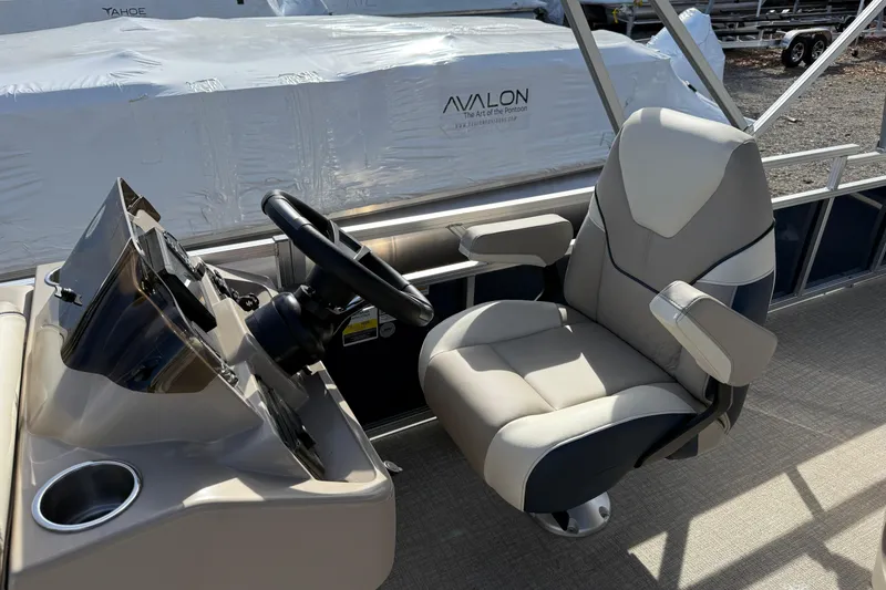 Slide: The Image of 2026 Avalon Venture 85 Rear Fish boat helm with comfortable captain's chair and steering wheel. - 11
