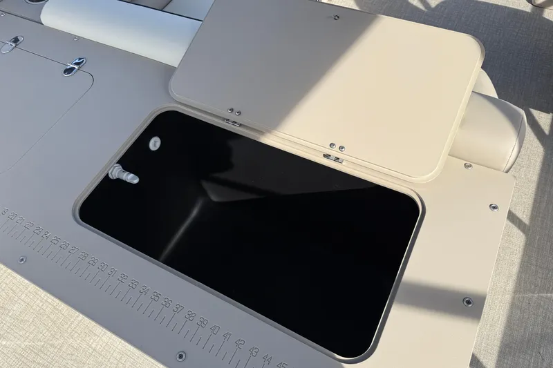 Slide: The Image of 2026 Avalon Venture 85 Rear Fish boat with open storage compartment and measurement markings. - 9