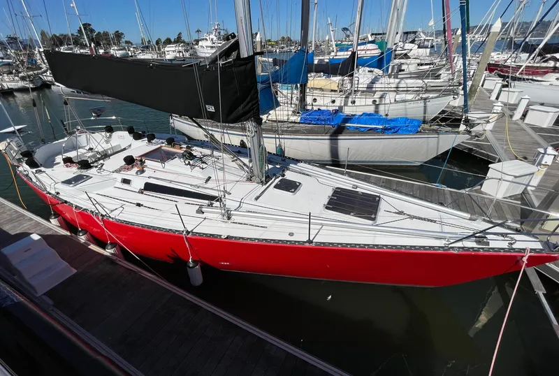 Slide: The Image of Aerial view of 1980 Davidson 44 sailboat with red spinnaker on ocean. - 1