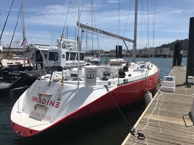 Slide: The Image of Red 1980 Davidson 44 sailboat docked in marina, surrounded by other boats. - 2