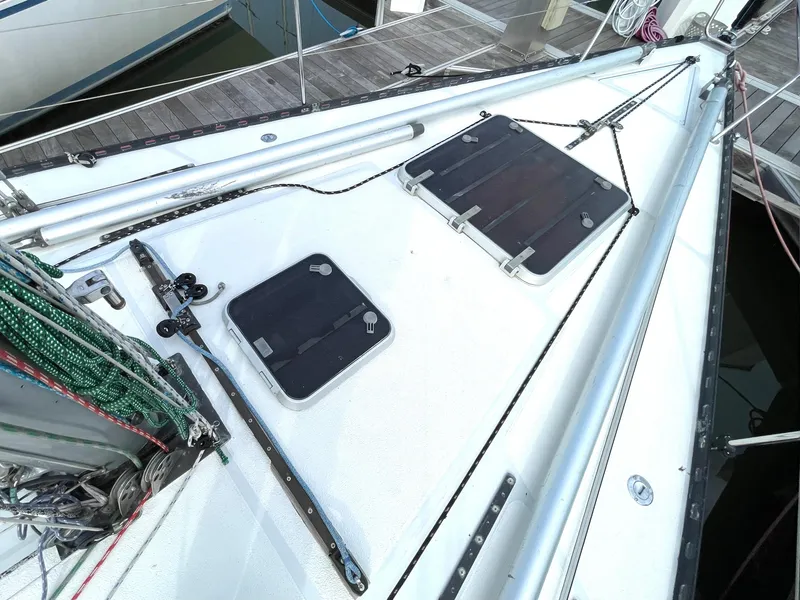 Slide: The Image of Cockpit of 1980 Davidson 44 sailboat with ropes and winches, docked by calm water. - 7
