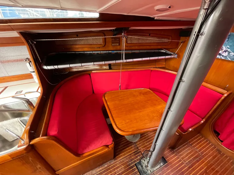 Slide: The Image of 1980 Davidson 44 yacht interior with red seating and wooden table. - 11