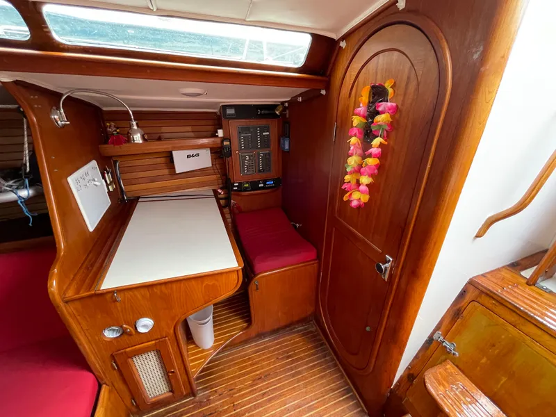 Slide: The Image of Interior of 1980 Davidson 44 sailboat with wooden finish and vibrant decor. - 13