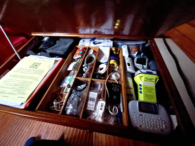Slide: The Image of Drawer with assorted items on a Davidson 44, 1980 model, including electronics and documents. - 14